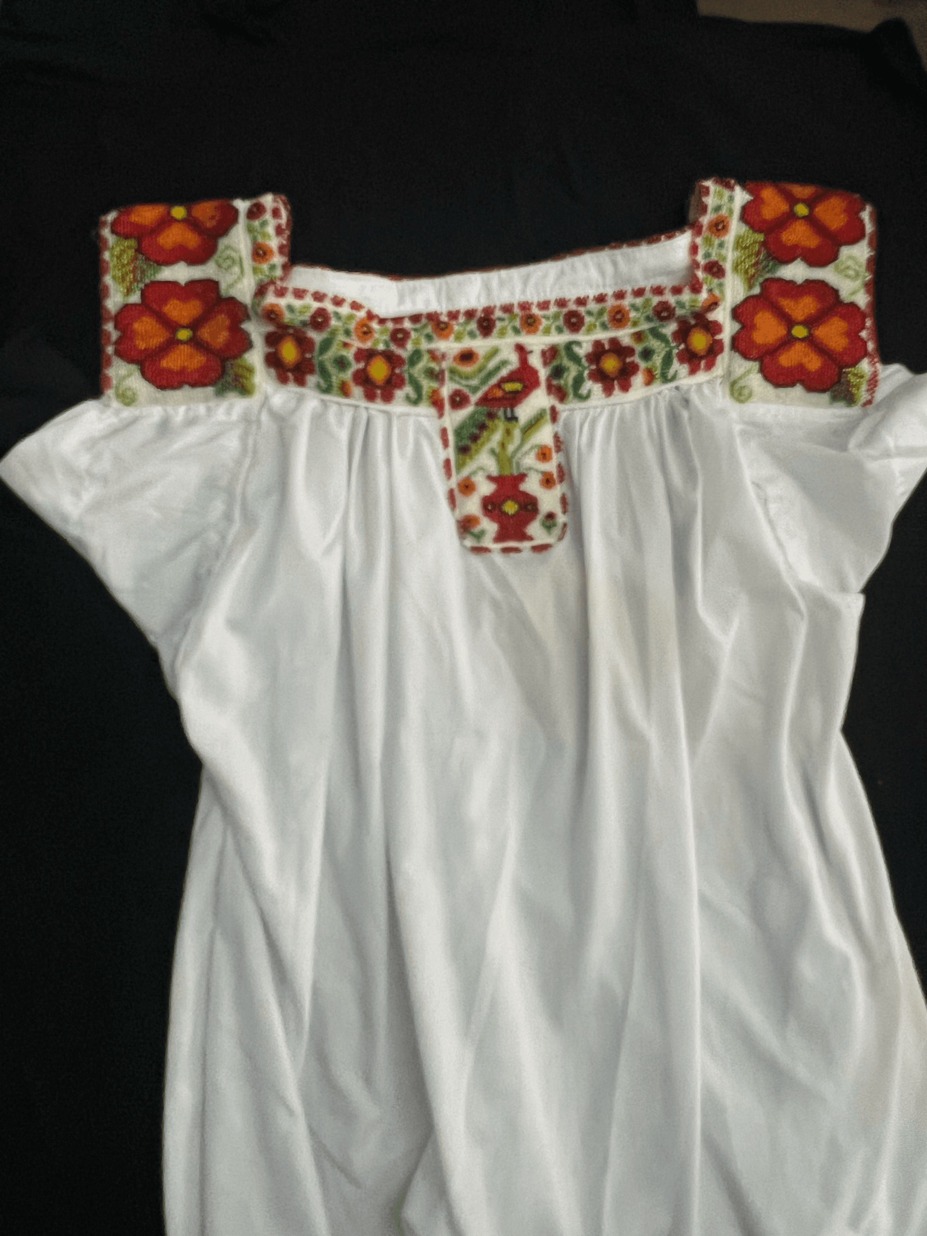 Handcrafted white folklórico dress displayed on a mannequin